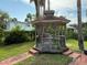 Charming wooden gazebo with seating, offering a relaxing outdoor retreat in a lush, green yard at 5018 Riverside Dr, Port Orange, FL 32127