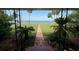 Inviting view of the water and city skyline from the porch, framed by tropical foliage and ironwork at 5018 Riverside Dr, Port Orange, FL 32127