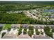 An aerial view of a neighborhood with mature trees, a lake, and well-maintained homes at 567 Mount Olympus Blvd, New Smyrna Beach, FL 32168