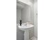 Modern powder room with pedestal sink, large mirror, and neutral decor at 567 Mount Olympus Blvd, New Smyrna Beach, FL 32168