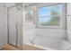 Bathroom with a glass shower and a garden tub at 567 Mount Olympus Blvd, New Smyrna Beach, FL 32168
