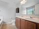 Bathroom with double vanity, toilet, and tub and shower at 567 Mount Olympus Blvd, New Smyrna Beach, FL 32168