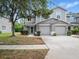 Well-maintained townhome featuring a two-car garage, tidy landscaping, and neutral color scheme at 567 Mount Olympus Blvd, New Smyrna Beach, FL 32168