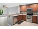 This kitchen has stainless appliances, wooden cabinets, and a large counter with seating at 567 Mount Olympus Blvd, New Smyrna Beach, FL 32168