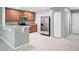 An updated kitchen featuring stainless steel appliances, light countertops, and wood cabinets at 567 Mount Olympus Blvd, New Smyrna Beach, FL 32168