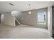 Open living space features tile floors, staircase, and a modern pendant light fixture at 567 Mount Olympus Blvd, New Smyrna Beach, FL 32168