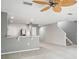 This wide open living room leads to the kitchen and has stairs to the upper level at 567 Mount Olympus Blvd, New Smyrna Beach, FL 32168