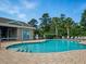 Community pool with brick trim, clear blue water, and plenty of seating for residents at 567 Mount Olympus Blvd, New Smyrna Beach, FL 32168