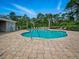 Beautiful community pool featuring lounge chairs and clear blue water surrounded by greenery at 567 Mount Olympus Blvd, New Smyrna Beach, FL 32168