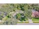 Aerial view of a home with a screened pool and lush landscaping, surrounded by mature trees at 6088 Sabal Hammock Cir, Port Orange, FL 32128