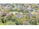 Aerial view of a neighborhood featuring a community pond and well-maintained homes with lush landscaping at 6088 Sabal Hammock Cir, Port Orange, FL 32128