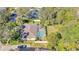 Expansive aerial view of the home, highlighting the screened pool and surrounding wooded landscape at 6088 Sabal Hammock Cir, Port Orange, FL 32128