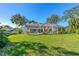 Expansive backyard featuring a screened-in lanai, lush greenery, and inviting outdoor living spaces at 6088 Sabal Hammock Cir, Port Orange, FL 32128