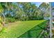 Spacious and well-manicured backyard with lush green grass, ideal for outdoor activities and relaxation at 6088 Sabal Hammock Cir, Port Orange, FL 32128