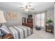Bedroom with map decor, carpet floors, and a bright window with sheer curtains at 6088 Sabal Hammock Cir, Port Orange, FL 32128