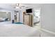 Bright bedroom with soft carpet, ceiling fan, and a glimpse into the en-suite bathroom and walk-in closet at 6088 Sabal Hammock Cir, Port Orange, FL 32128