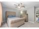 Cozy bedroom featuring plush carpet, ceiling fan, and a soft upholstered bed at 6088 Sabal Hammock Cir, Port Orange, FL 32128