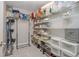 Walk-in closet with wire shelving, filled with storage containers and household items at 6088 Sabal Hammock Cir, Port Orange, FL 32128