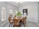 Bright dining room with wood flooring, arched windows, and decorative molding at 6088 Sabal Hammock Cir, Port Orange, FL 32128