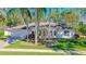 Charming single-story home with a well-manicured lawn, mature trees, and a two-car garage at 6088 Sabal Hammock Cir, Port Orange, FL 32128