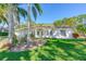 Charming single-story home featuring a well-manicured lawn and mature palm trees at 6088 Sabal Hammock Cir, Port Orange, FL 32128