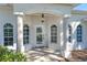 Home's inviting front porch with decorative columns, arched windows, and a tiled entryway at 6088 Sabal Hammock Cir, Port Orange, FL 32128