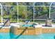 Relaxing screened-in spa with tiled surround and elegant stone accents, perfect for enjoying the outdoors at 6088 Sabal Hammock Cir, Port Orange, FL 32128