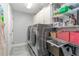 Laundry area features front loading washer and dryer with shelving for storage at 6088 Sabal Hammock Cir, Port Orange, FL 32128