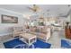 Inviting living room features neutral tones, a comfortable seating arrangement, and seamless flow into the kitchen and dining areas at 6088 Sabal Hammock Cir, Port Orange, FL 32128