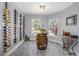 Charming wine room features custom wine racks, a barrel table, and natural light creating a sophisticated space at 6088 Sabal Hammock Cir, Port Orange, FL 32128
