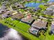 An aerial view of a green backyard with a pond, highlighting its position and beautiful landscaping at 637 Marisol Dr, New Smyrna Beach, FL 32168