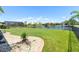 Lush backyard with well-maintained lawn, pond view, and serene setting at 637 Marisol Dr, New Smyrna Beach, FL 32168