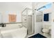 Bright bathroom with a soaking tub, separate shower, and an arched window at 637 Marisol Dr, New Smyrna Beach, FL 32168