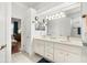 Bright bathroom features double sinks, ample storage, and access to the bedroom at 637 Marisol Dr, New Smyrna Beach, FL 32168