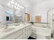 Bright bathroom with dual sinks, soaking tub and separate glass enclosed shower at 637 Marisol Dr, New Smyrna Beach, FL 32168