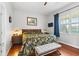 Cozy bedroom with hardwood floors, floral bedding, and a view of the outdoors at 637 Marisol Dr, New Smyrna Beach, FL 32168
