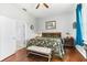 Well-lit bedroom with hardwood floors, a ceiling fan, and a comfortable bed at 637 Marisol Dr, New Smyrna Beach, FL 32168
