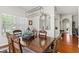 Bright dining room featuring a dark wood table with decorative lighting and large windows at 637 Marisol Dr, New Smyrna Beach, FL 32168