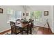 Well-lit dining room with an elegant table setting and views through large windows at 637 Marisol Dr, New Smyrna Beach, FL 32168