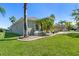 A green lawn and well-manicured shrubbery surround the exterior of this well-maintained home at 637 Marisol Dr, New Smyrna Beach, FL 32168