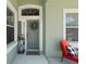 Close up of the front door and porch area with black and white decor, creating a inviting entrance at 637 Marisol Dr, New Smyrna Beach, FL 32168