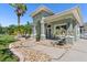 Landscaped walkway leads to a charming home with a covered front porch seating area at 637 Marisol Dr, New Smyrna Beach, FL 32168