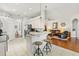 Open kitchen with breakfast bar, white cabinets, and flows into living area at 637 Marisol Dr, New Smyrna Beach, FL 32168