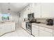 Bright kitchen features stainless appliances, tile floors, and ample white cabinetry for storage at 637 Marisol Dr, New Smyrna Beach, FL 32168