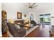 Bright living room with leather seating, hardwood floors, and sliding glass doors to the patio at 637 Marisol Dr, New Smyrna Beach, FL 32168