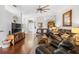 Comfortable living room with hardwood floors, leather sofas, and a ceiling fan at 637 Marisol Dr, New Smyrna Beach, FL 32168