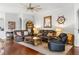 Inviting living room with leather furniture, a ceiling fan, and charming nautical decor at 637 Marisol Dr, New Smyrna Beach, FL 32168
