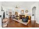 Open-concept living room with hardwood floors, leather furniture, and nautical-themed decor at 637 Marisol Dr, New Smyrna Beach, FL 32168