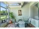 Covered porch boasts outdoor seating and view of the lush yard and landscaping at 637 Marisol Dr, New Smyrna Beach, FL 32168