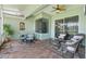 Relaxing porch features comfortable seating and views of the home's exterior and backyard at 637 Marisol Dr, New Smyrna Beach, FL 32168